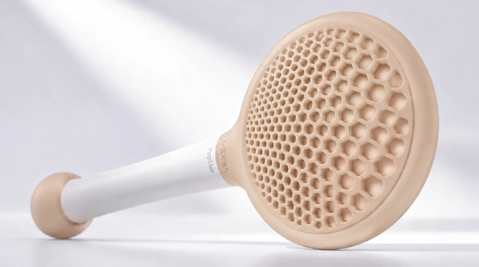CoQ10 formulation concept device with a sage-green perforated pad on a white handle